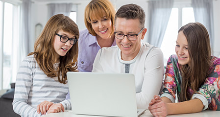 Group of 4 family enjoying the laptop
